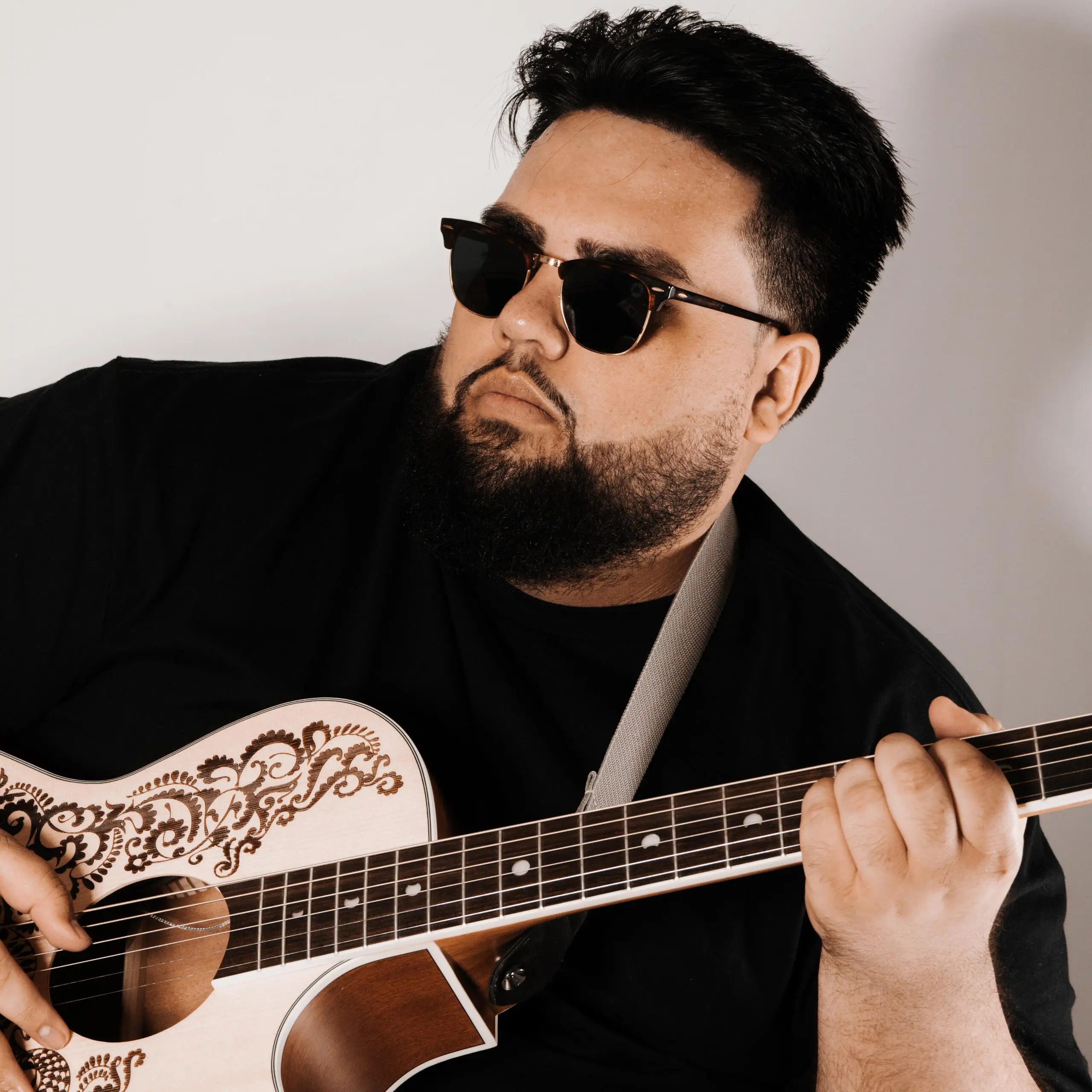 Kingmichael holding an acoustic guitar